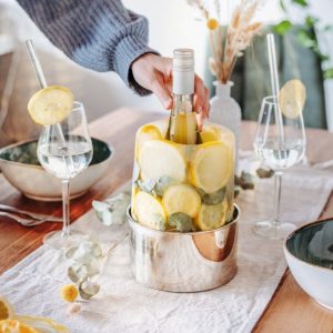 Rafraichisseur de bouteilles créatif avec citrons et plantes sur une table