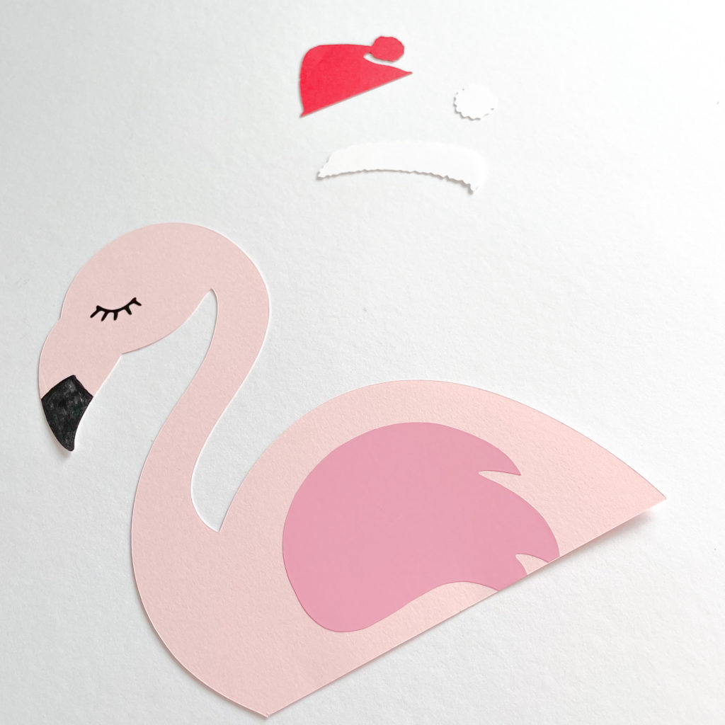 silhouette de flamant rose en papier avec une aile rose