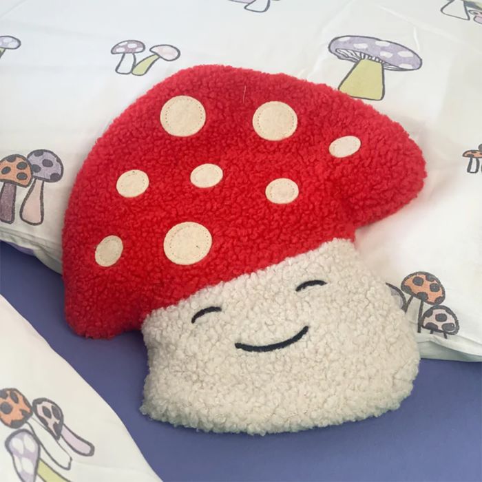 Coussin chauffant en forme de champignon souriant rouge et blanc